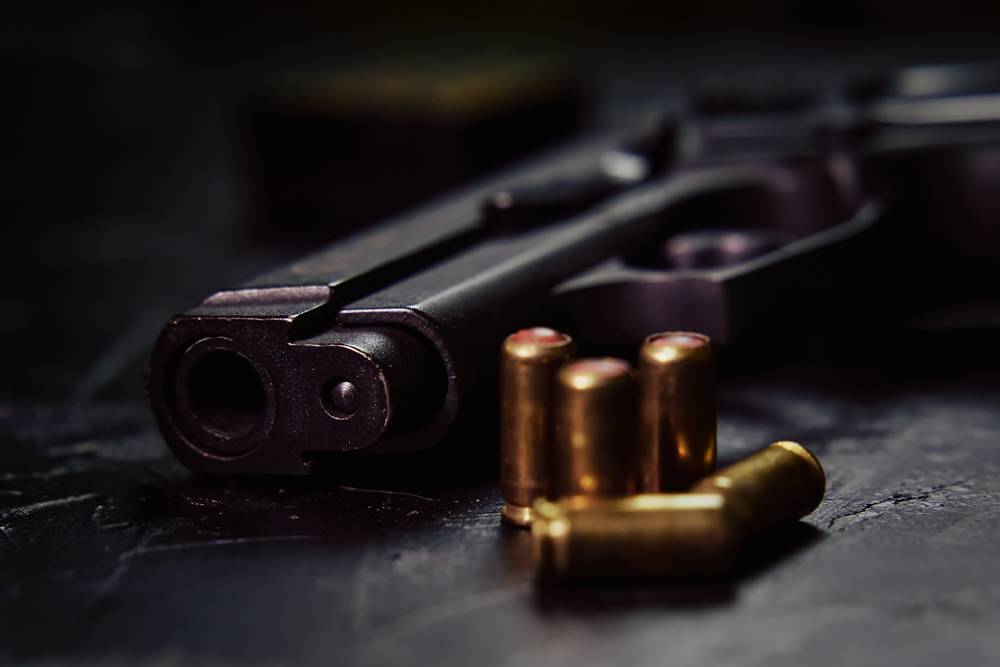 Firearms,On,Concrete,Background.,Close-up,Of,Gunpoint,And,Bullets,On
